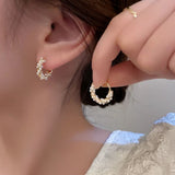 Boucles d'oreilles torsadées à détails de perle